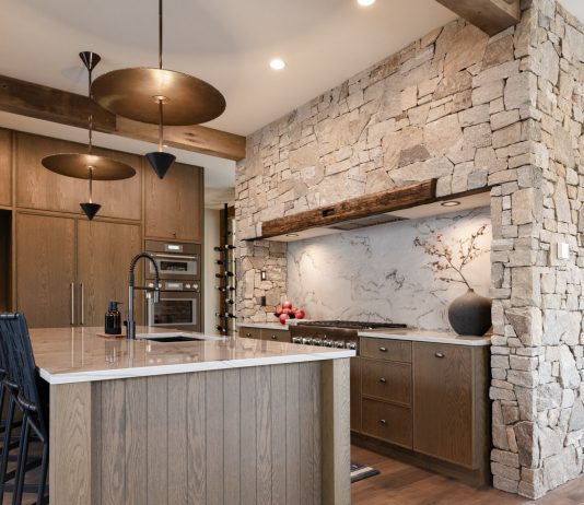 Mountain Living Redefined: A Buyer’s Guide The kitchen in Sapphire Summit features wood from floor to ceiling, including reclaimed wood beams from Manomin Resawn Timbers.