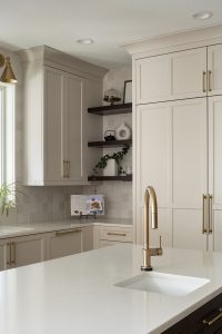 A kitchen with neutral colored cabinets and floating shelves from Revival House