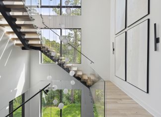 Large windows, a winding staircase, and local Hennepin Made lighting fixtures are on display in this sustainable home from Sustainable 9 + Design and Unfold Architecture