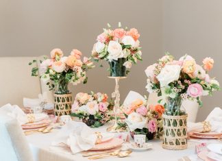 Varying heights and vessels add visual interest to floral arrangements at the dining table