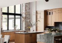 The chef’s-style kitchen features a spacious pantry and dual islands topped with quartzite, one with a unique half-waterfall countertop.