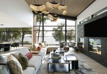 Natural light pours into the great room of this modern Minnesota lake home, complete with stunning lake views and sculptural lighting.