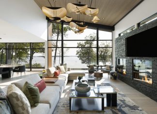 Natural light pours into the great room of this modern Minnesota lake home, complete with stunning lake views and sculptural lighting.