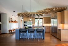 This ceiling structure brings warmth and artful function to this expansive, vaulted kitchen.