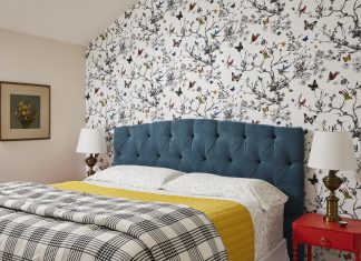 Schumacher wallpaper, a custom velvet headboard, and colorful nightstand make this guest suite stand out.